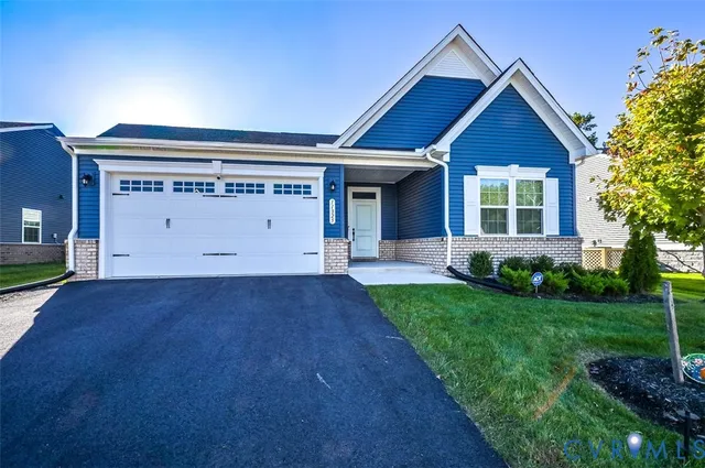 a view of house with backyard and garden