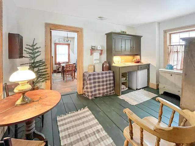 a living room with furniture and a dining table with rug
