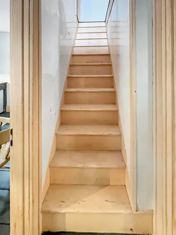 a view of staircase with white walls