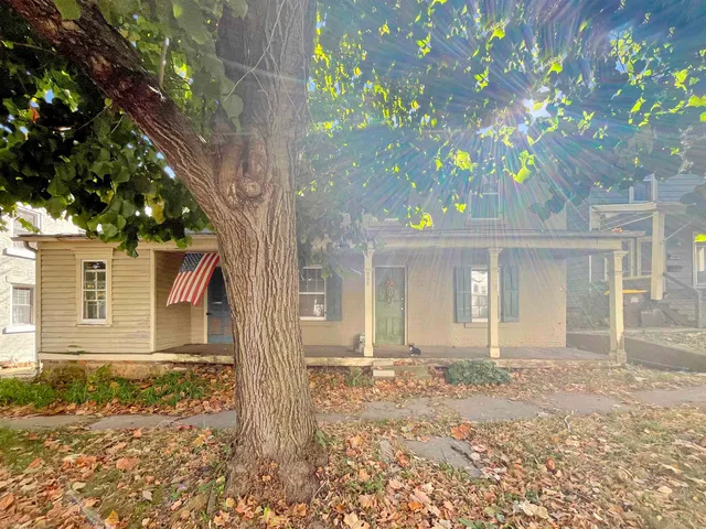 front view of a house with a tree