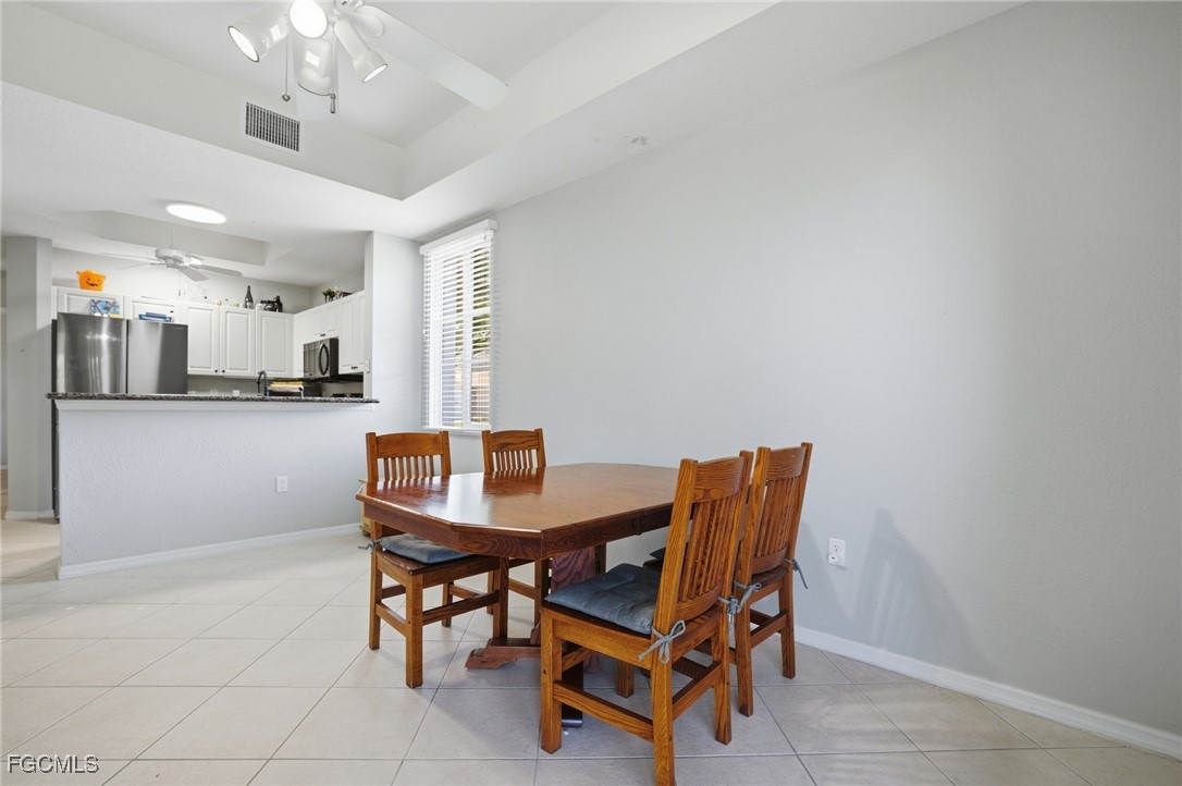 13160 Broadhurst Loop, Unit 101 Fort Myers, FL 33919 - Photo 14 of 39 a dining room with furniture and kitchen view
