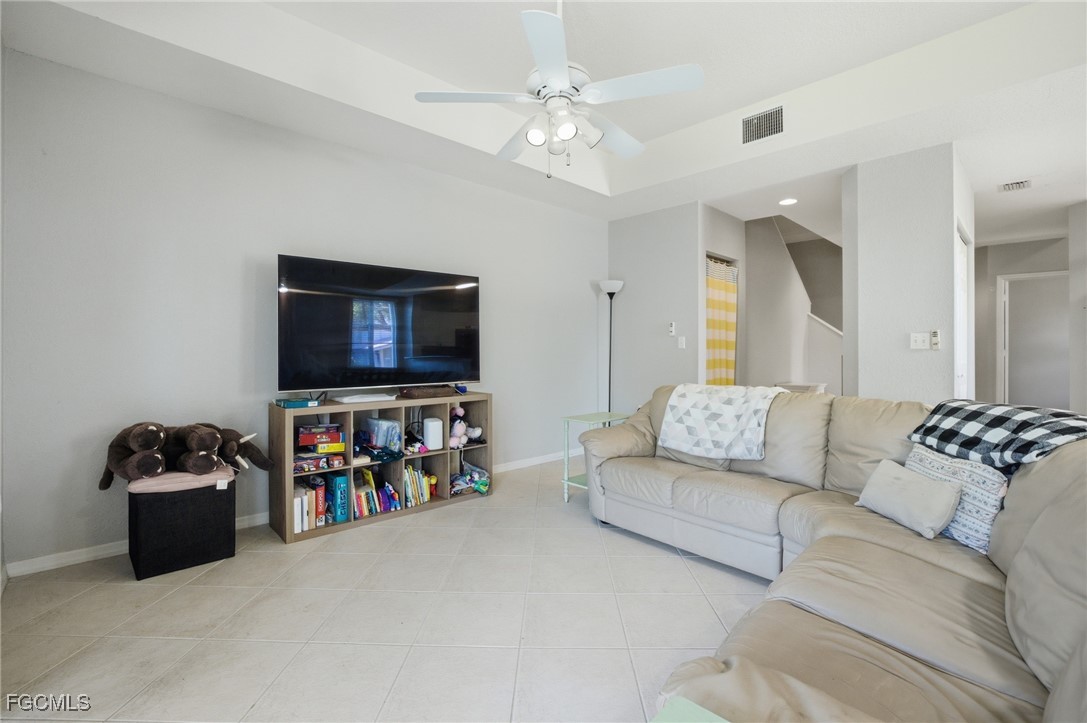 13160 Broadhurst Loop, Unit 101 Fort Myers, FL 33919 - Photo 15 of 39 a living room with furniture and a flat screen tv