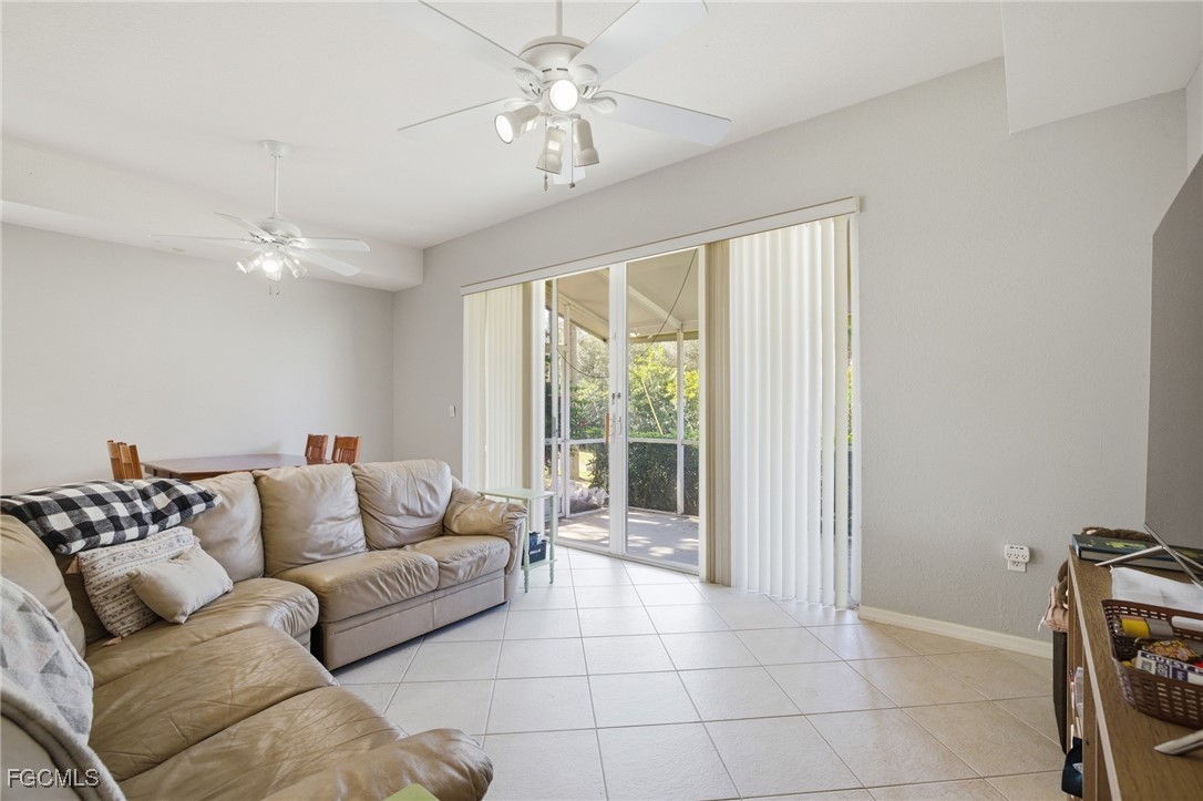 13160 Broadhurst Loop, Unit 101 Fort Myers, FL 33919 - Photo 17 of 39 a living room with furniture and a chandelier