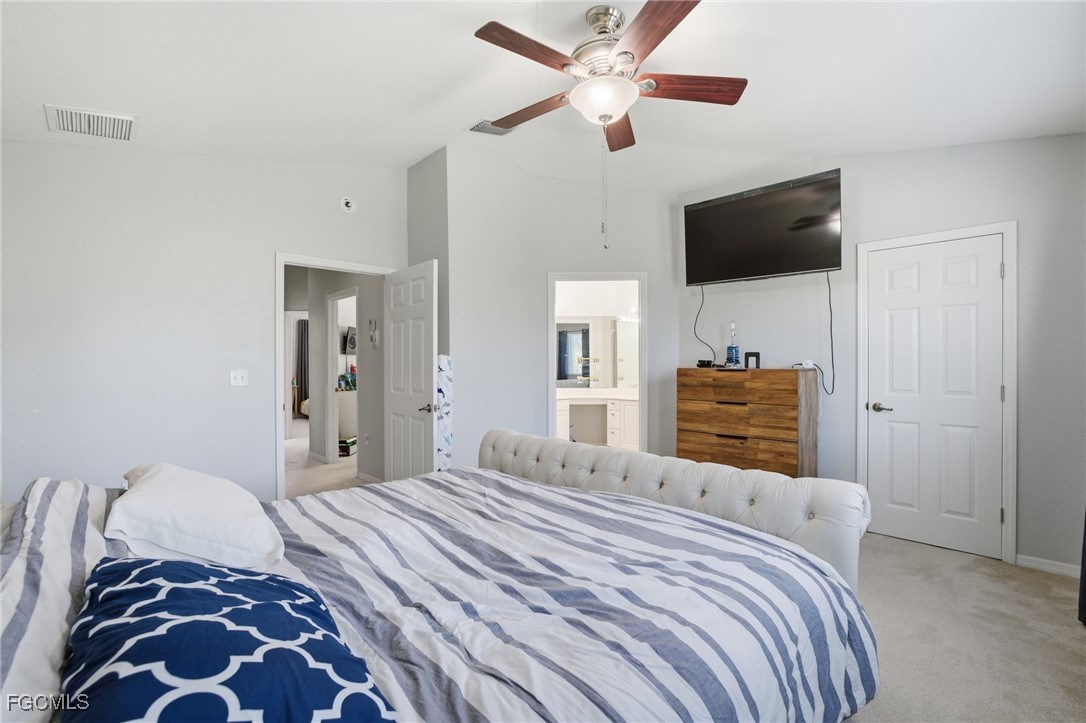 13160 Broadhurst Loop, Unit 101 Fort Myers, FL 33919 - Photo 22 of 39 a bedroom with a bed and a flat screen tv