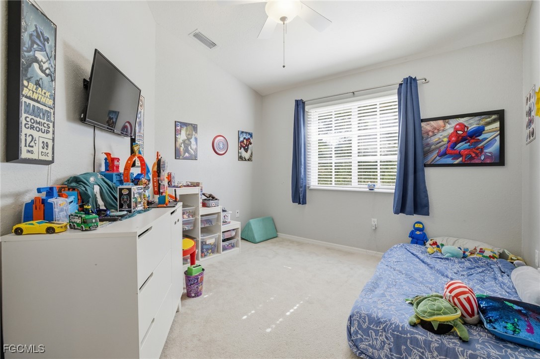 13160 Broadhurst Loop, Unit 101 Fort Myers, FL 33919 - Photo 25 of 39 a bedroom with toys and a flat screen tv