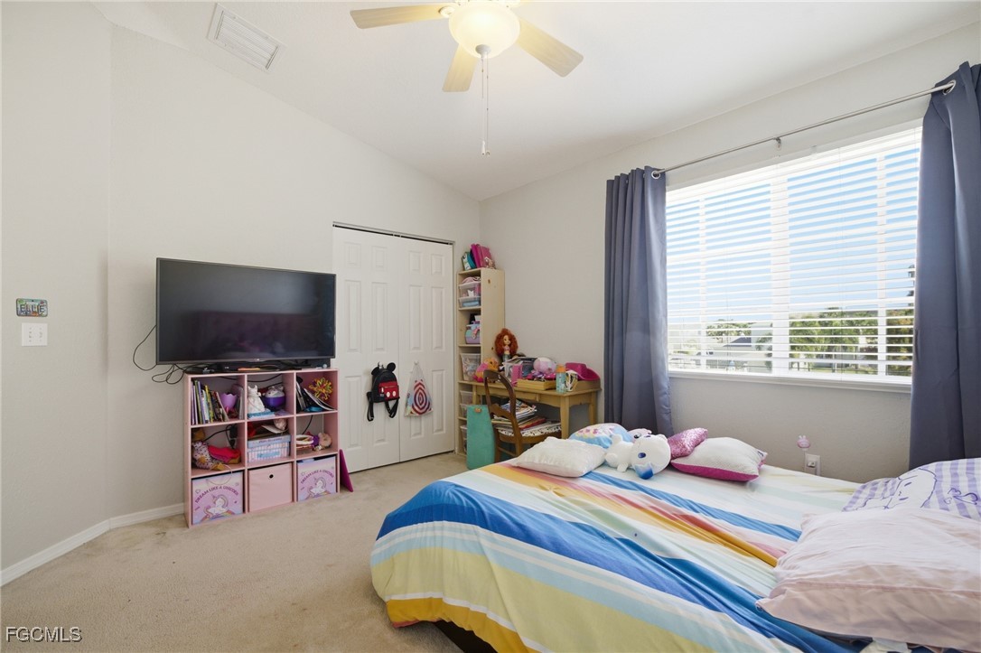 13160 Broadhurst Loop, Unit 101 Fort Myers, FL 33919 - Photo 29 of 39 a bedroom with bed and a flat tv screen on the dresser