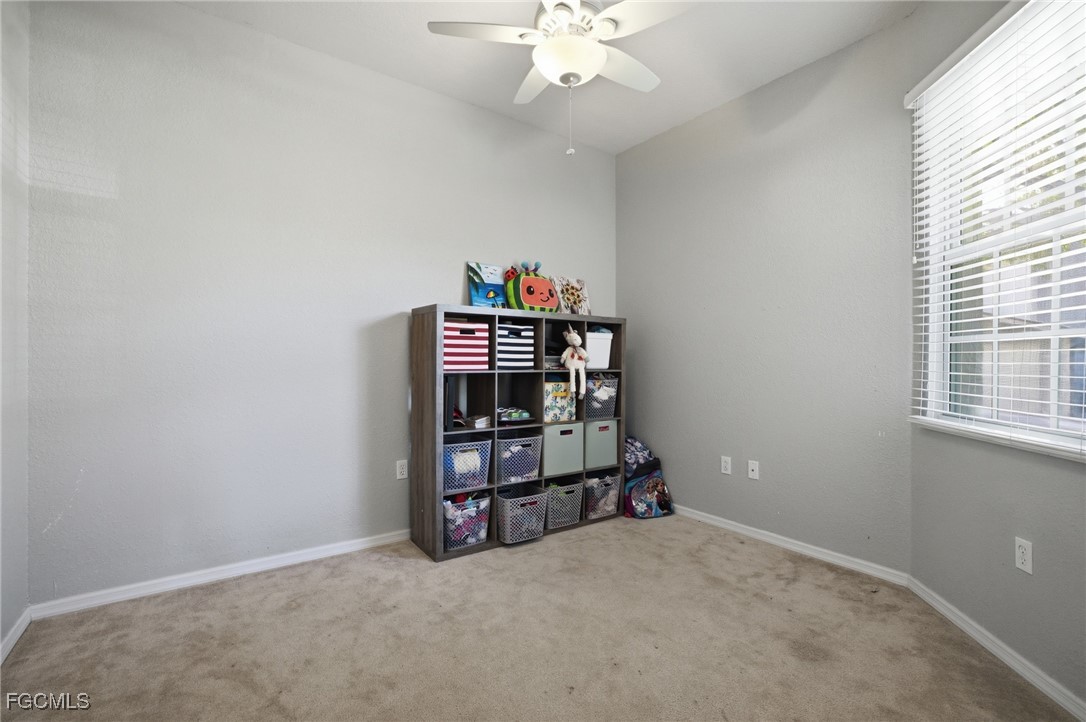 13160 Broadhurst Loop, Unit 101 Fort Myers, FL 33919 - Photo 3 of 39 an empty room with bookshelf and a window