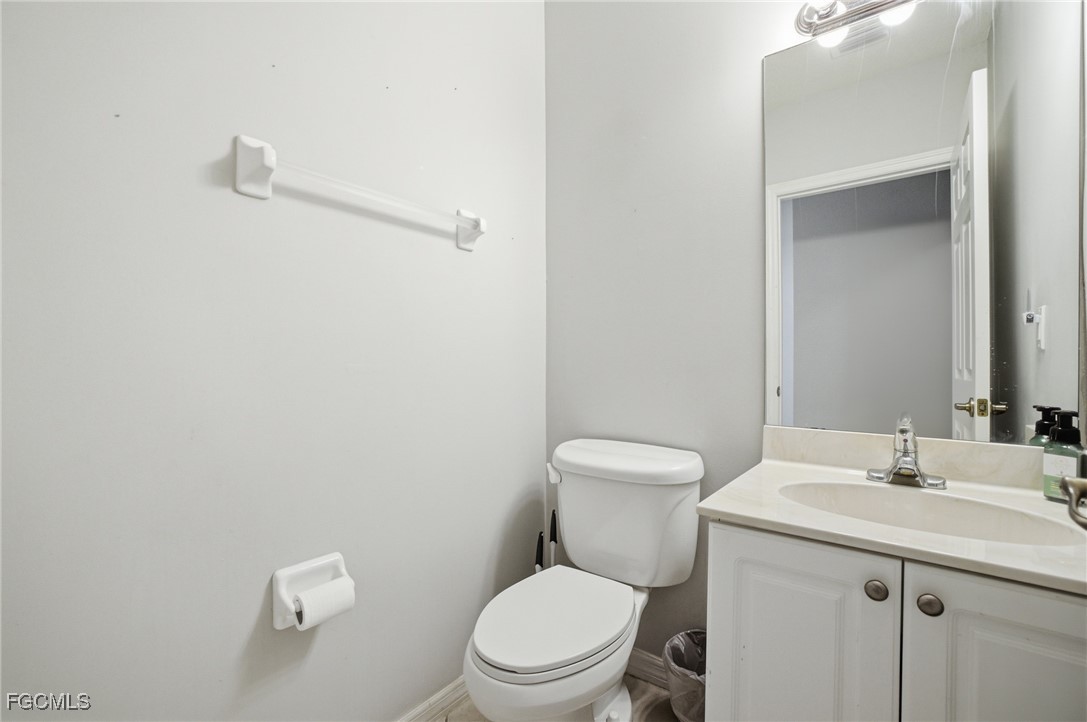 13160 Broadhurst Loop, Unit 101 Fort Myers, FL 33919 - Photo 6 of 39 a bathroom with a toilet sink and mirror