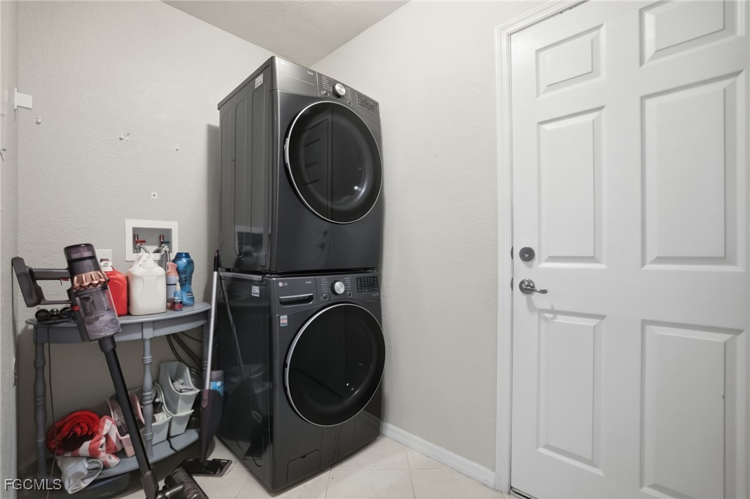 13160 Broadhurst Loop, Unit 101 Fort Myers, FL 33919 - Photo 7 of 39 a utility room with dryer washer and closet