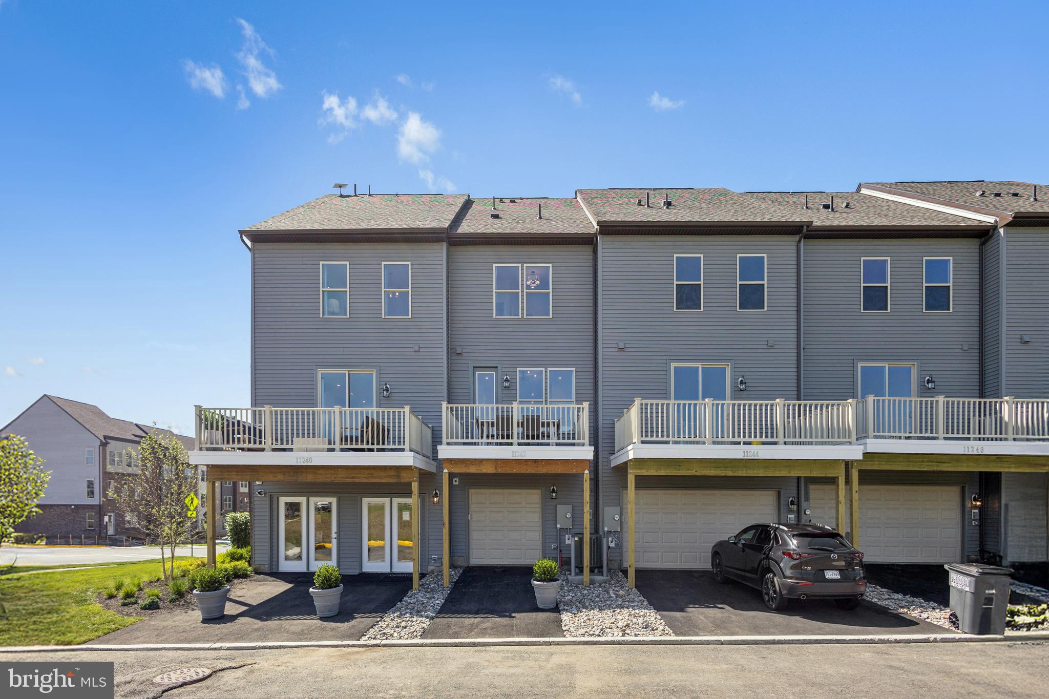 11221 Einstein Street Manassas, VA 20110 - Photo 17 of 23 a front view of residential houses with yard