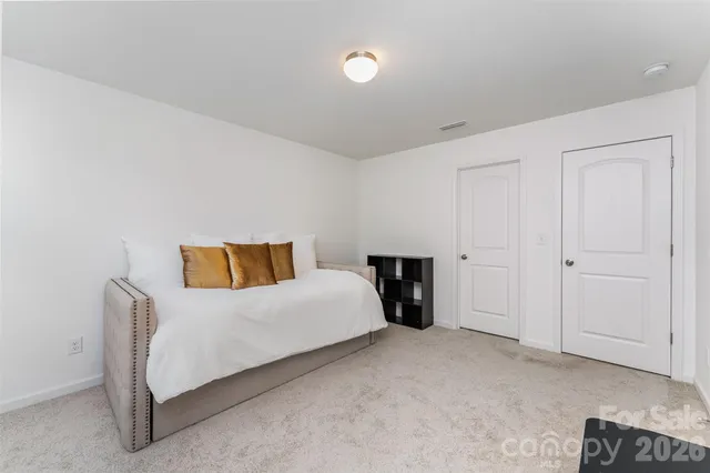 a spacious bedroom with a bed and a couch