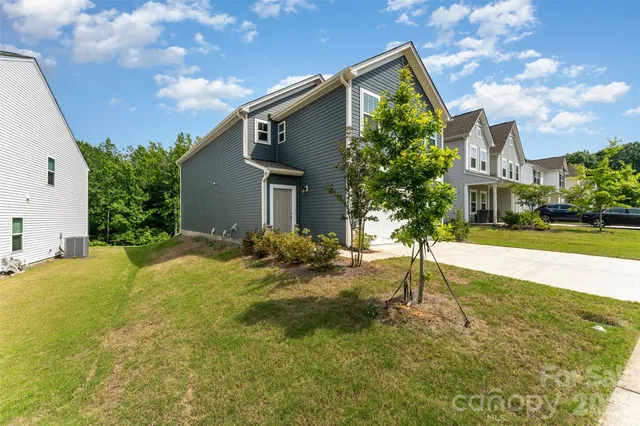 a house view with swimming pool in front of it