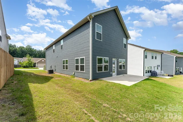 a view of a house with a yard and sitting area