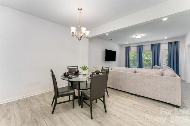 a view of a dining room with furniture wooden floor and chandelier