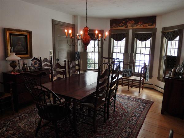 317 Worcester Road Princeton, MA 01541 - Photo 16 of 23 a view of a dining room and livingroom with furniture wooden floor a rug a potted plant and a chandelier