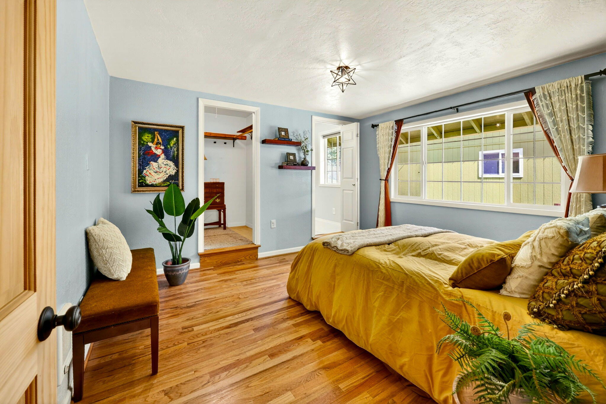 51 Sterling Creek Road Jacksonville, OR 97530 - Photo 22 of 54 a bedroom with a bed and wooden floor
