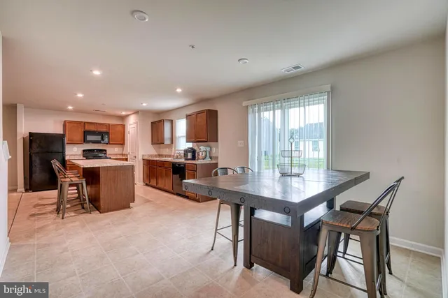 a view of a dining room with furniture and a kitchen