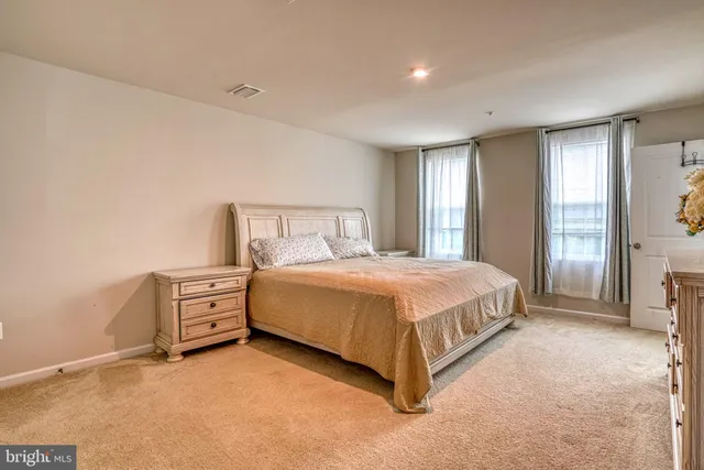 a spacious bedroom with a bed and window