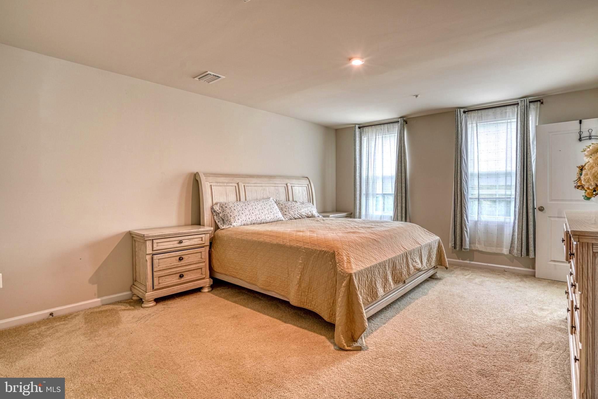 11 Saddle Bill Circle Cambridge, MD 21613 - Photo 18 of 31 a spacious bedroom with a bed and window