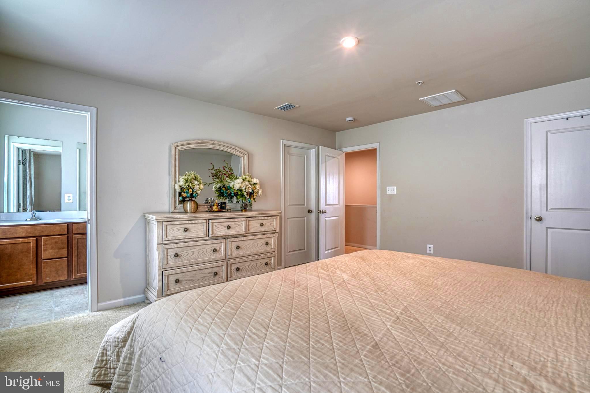 11 Saddle Bill Circle Cambridge, MD 21613 - Photo 20 of 31 a bedroom with a bed and a dresser