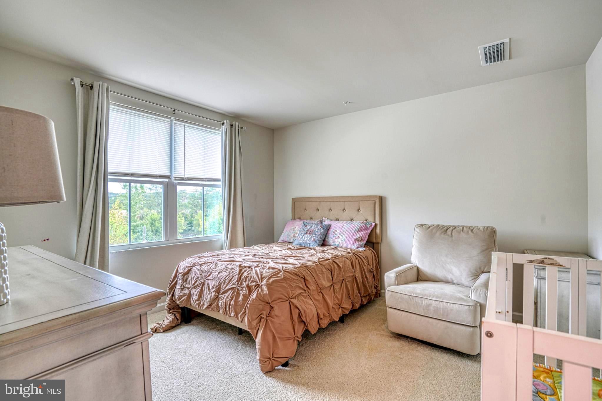 11 Saddle Bill Circle Cambridge, MD 21613 - Photo 23 of 31 a bedroom with a bed and a couch