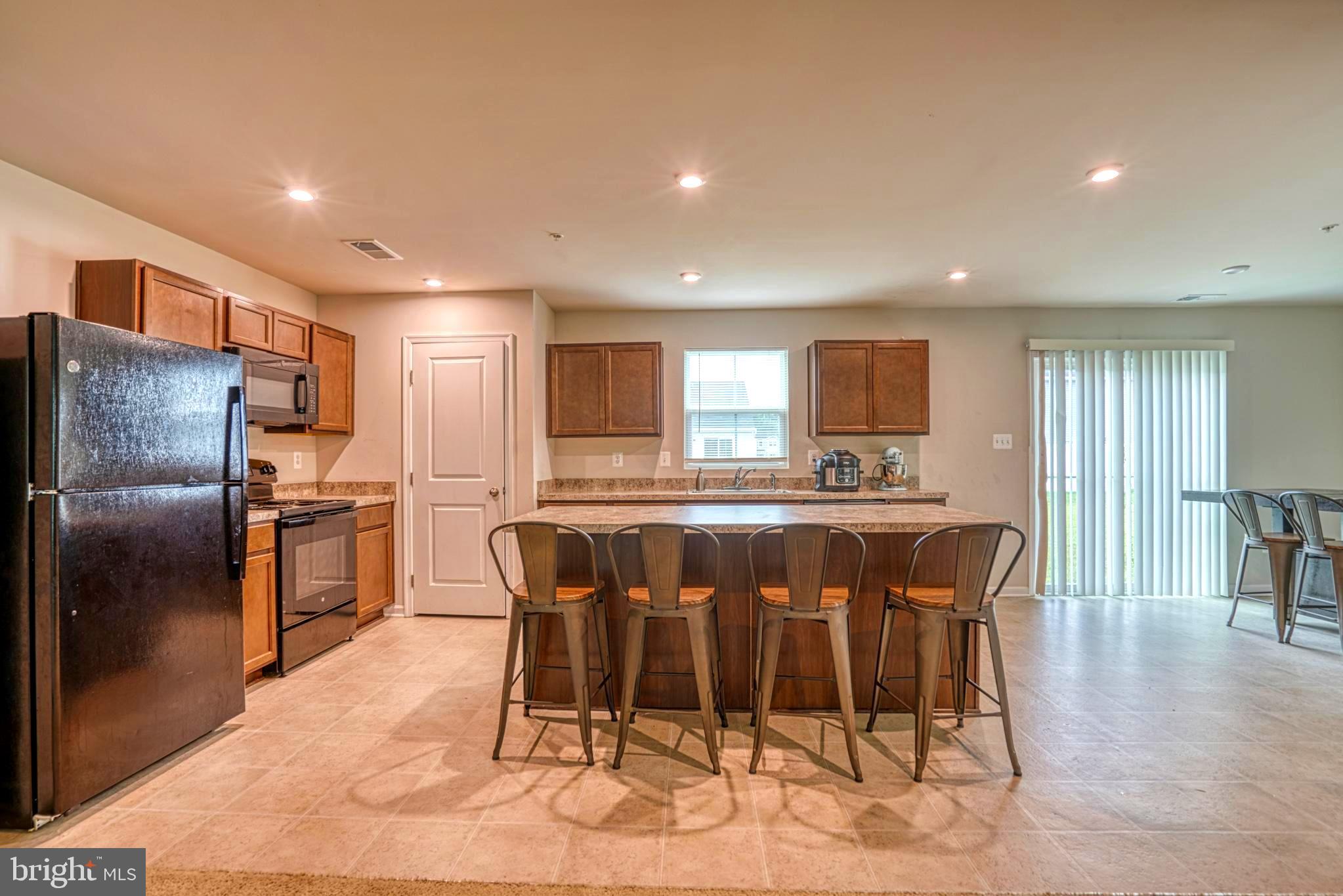 11 Saddle Bill Circle Cambridge, MD 21613 - Photo 5 of 31 a large kitchen with a table and chairs