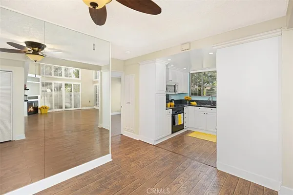 a kitchen with stainless steel appliances granite countertop a sink a stove and a refrigerator
