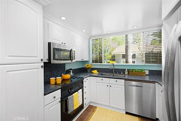 a kitchen with a sink a counter and appliances