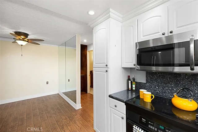a kitchen with a refrigerator and a stove