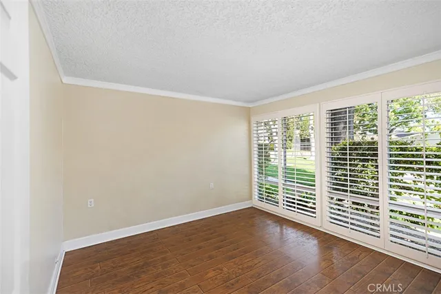 a view of wooden floor and windows in a room