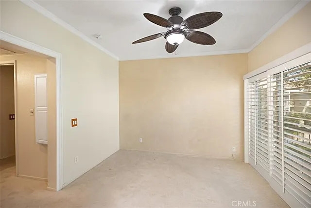 a view of empty room with ceiling fan