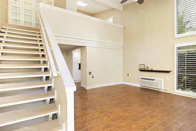 a view of staircase with white walls and windows