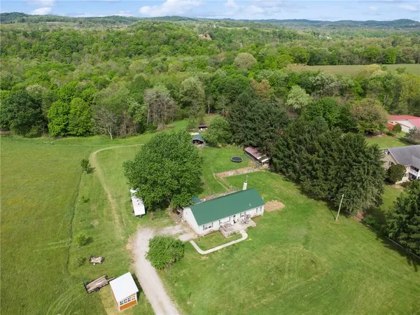 an aerial view of a house with a yard