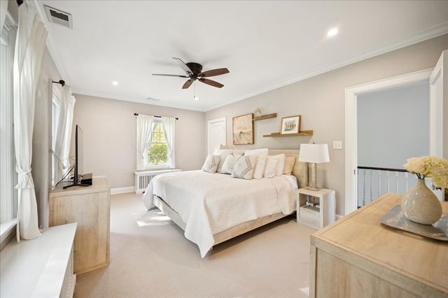 a spacious bedroom with a bed and a dresser