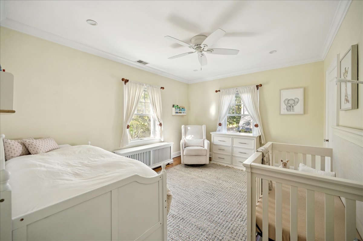 305 Poplar Street Winnetka, IL 60093 - Photo 20 of 26 a bedroom with a bed and a chandelier