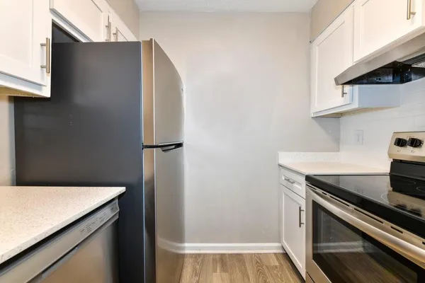 a kitchen with a refrigerator and a stove