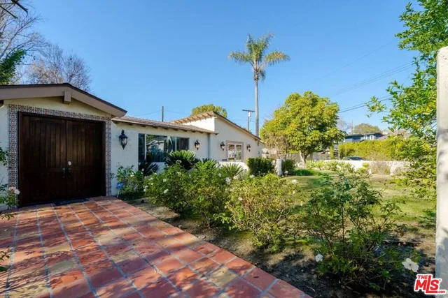 a bathroom with a granite countertop tub a sink and a window