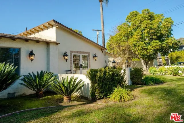 a view of a dining room with furniture and a potted plant