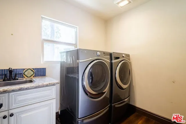 a view of a patio with table and chairs with wooden floor and fence