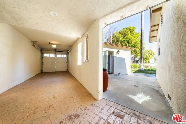 a living room with furniture a wooden floor and next to a window