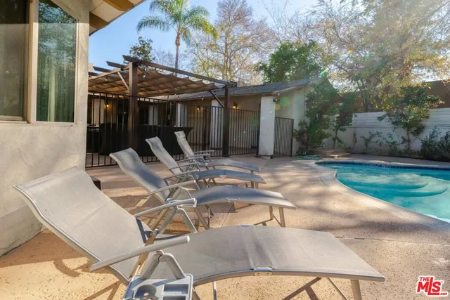 a kitchen with granite countertop a refrigerator and a sink