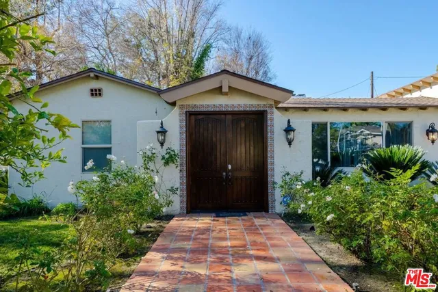 a kitchen with granite countertop a sink stove and refrigerator