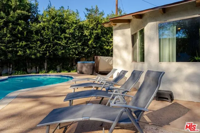 a kitchen with stainless steel appliances granite countertop a sink window and cabinets