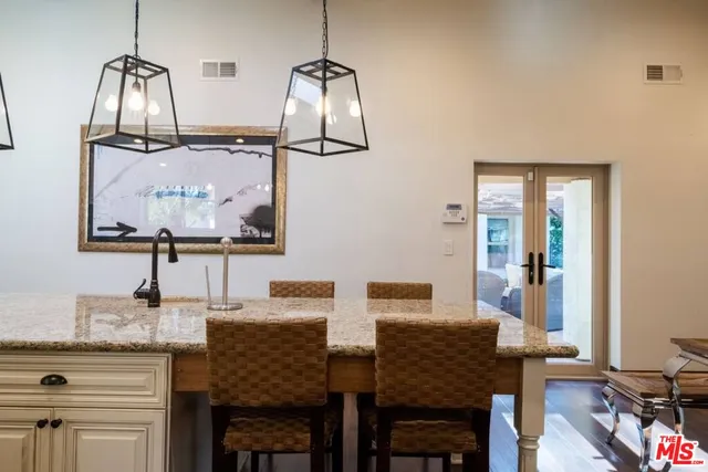 a view of a dining room with furniture a rug and wooden floor