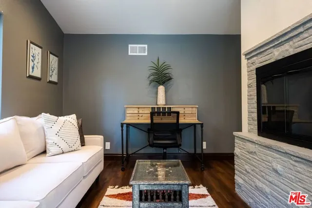 a bedroom with a bed and a painting on the wall