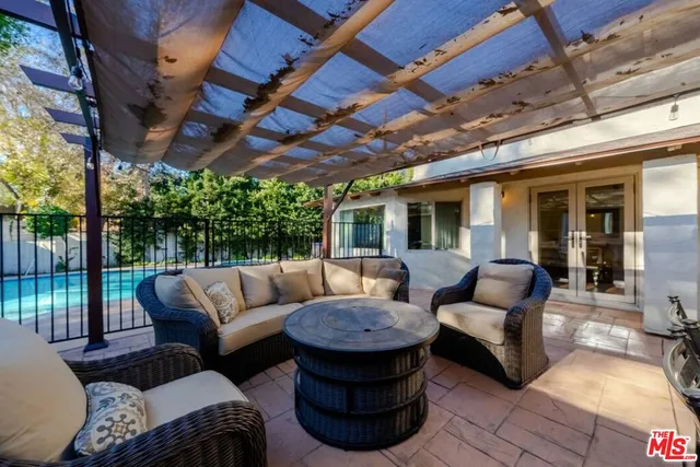 a bedroom with a large bed and wooden floor