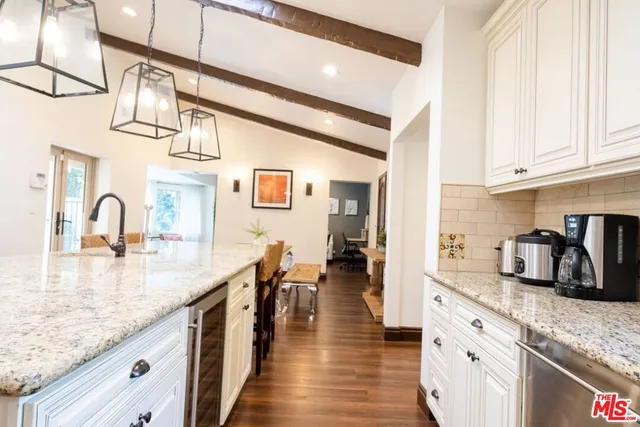 a bedroom with a large bed and wooden floor