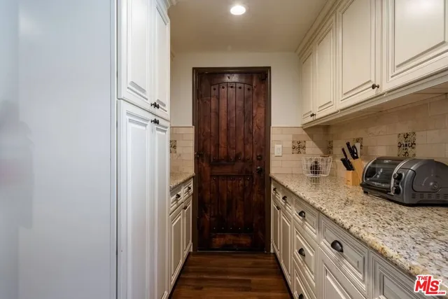 a outdoor dining area with furniture and wooden floor