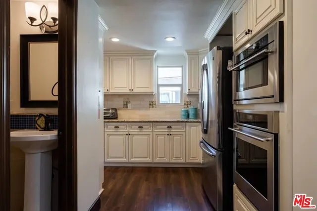 a bathroom with a granite countertop sink mirror and a shower