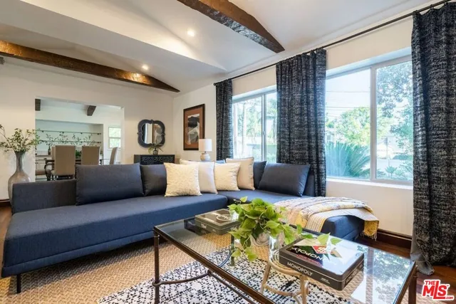 a living room with furniture fireplace and wooden floor